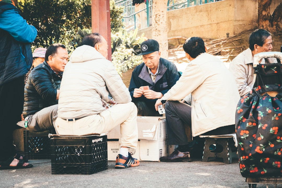 Group of men sitting together in prayer and discipleship with open Bible