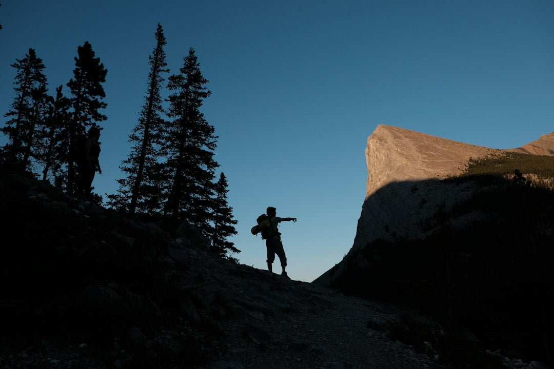 Silhouette of a man hiking a mountain representing strength and discipline