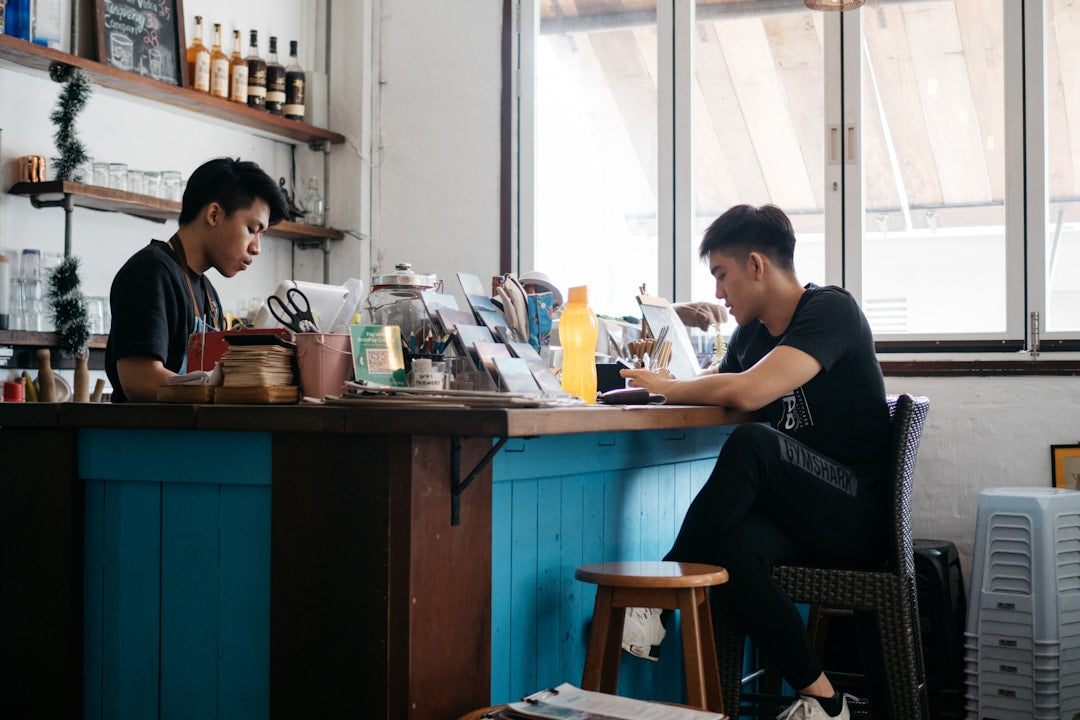 Man engaging in conversation at a coffee shop, illustrating casual mentorship and discipleship