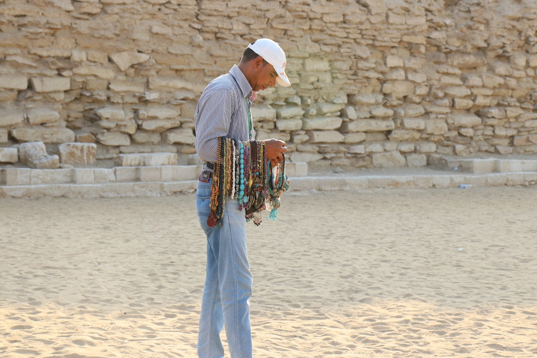 Christian man praying over an open Bible, seeking to live as a true disciple of Christ | Good Guy Gear Christian apparel